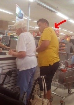 A father performs a generous act for an elderly woman at the grocery store.